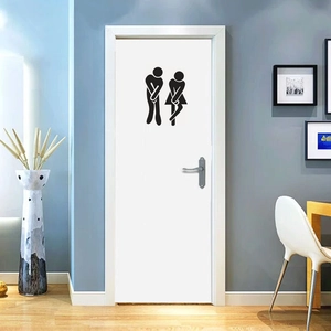 Detailed view of creative funny stickman toilet door decals on a modern white door