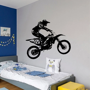Black motocross rider silhouette wall decal jumping over bed in a boy bedroom decor