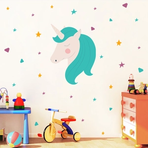 Detail view of unicorn wall decal with pastel stars and diamonds in a kids playroom