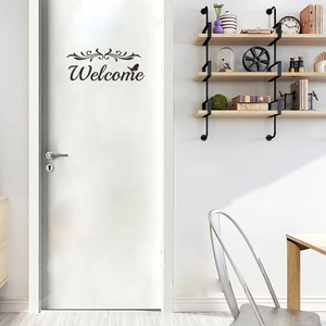Minimalist black Welcome wall sticker with butterfly and scroll design on white door