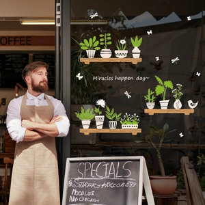 Creative potted plants wall stickers on a glass door with Miracles happen day text