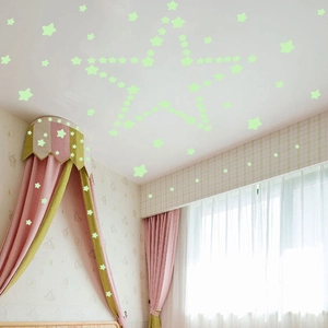 Luminous glow-in-the-dark star wall stickers forming a large pattern in a kids bedroom