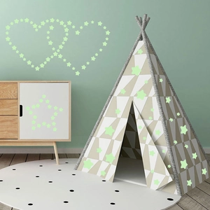 Luminous star wall stickers arranged in heart and star shapes in a cozy nursery room