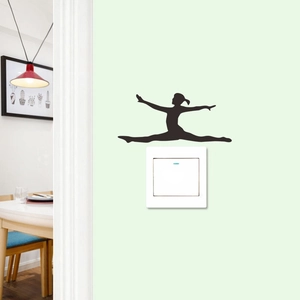 Detail showing a black silhouette of a ballerina wall sticker placed above a white light switch