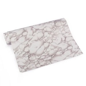 Macro detail of self-adhesive white marble wallpaper roll with grey veins for furniture
