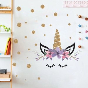 Golden glitter unicorn wall stickers with pink floral accents and polka dots for nursery