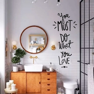 Detail of 'Do What You Love' black inspirational wall sticker in a modern bathroom
