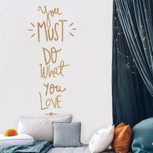 Close-up of golden glitter wall sticker with You Must Do What You Love inspirational quote