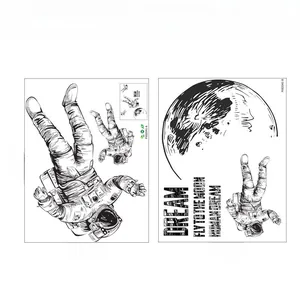 Detail showing two sheets of black line art astronaut wall stickers with size markings