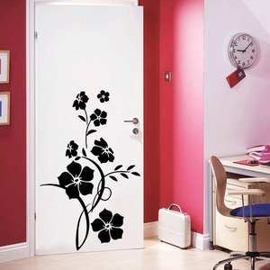 Minimalist black floral wall decal with vine design on a white door in a modern room decor