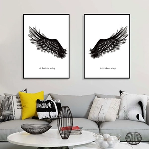 Modern black wings art prints with minimalist frames and A Broken Wing text for living room