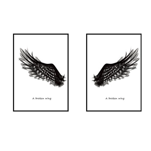 Modern black wings wall art set with A Broken Wing typography in minimalist black frames
