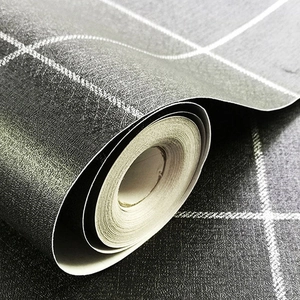 Detail view of dark grey self-adhesive wallpaper with white grid and embossed texture