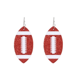 Sparkly red glitter football earrings with white athletic stripes and silver hooks
