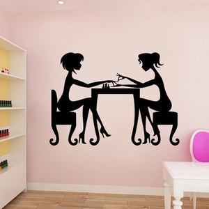 Black vinyl wall decal featuring two girls in a nail salon scene for beauty room decor