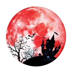 Close-up of luminous Halloween wall sticker with red moon, castle silhouette and bats