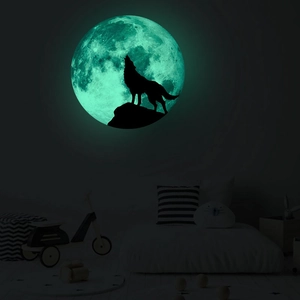 Luminous wall sticker showing a howling wolf silhouette against a glowing moon in the dark