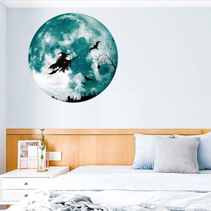 Luminous Halloween wall sticker featuring a witch on a broom with a glowing blue moon
