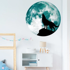 Luminous wall sticker showing a blue full moon and howling wolf silhouette in a bedroom