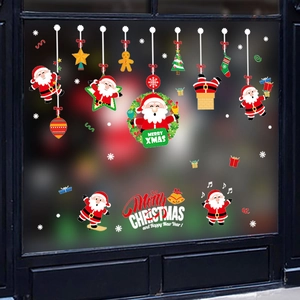 Christmas window decals with Santa, tree, and Merry Xmas text on black window glass
