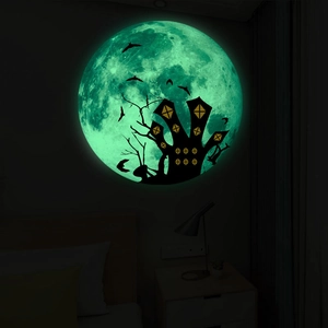 Sticker mural Halloween lumineux montrant une lune brillante avec silhouettes de château