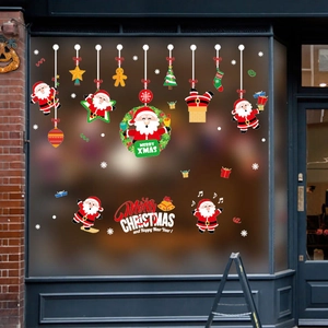 Festive Christmas wall stickers featuring Santa Claus and tree on a glass shop window