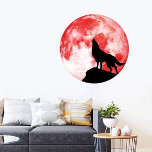 Glow-in-the-dark moon wall sticker featuring a wolf silhouette on a red textured surface