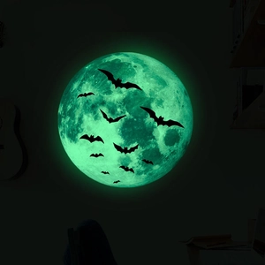 Luminous Halloween wall stickers featuring a glowing moon and black bat silhouettes in the dark