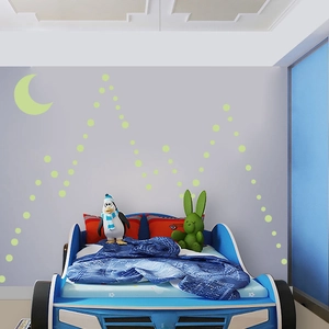 Luminous moon and dot wall decals set for kid room decor on a grey wall surface
