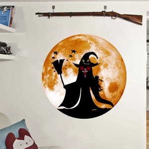 Detail of Halloween wall sticker featuring a large orange moon and witch silhouette