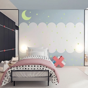 Glow in the dark moon and dot wall stickers decorating a cozy children bedroom wall