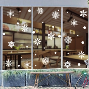 Winter window display featuring elegant white snowflake static stickers for Christmas