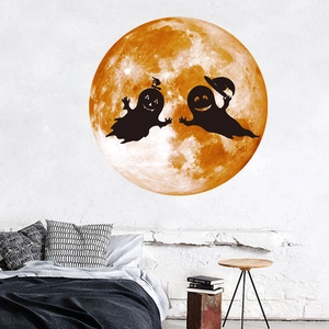 Close-up of luminous moon wall sticker with ghost silhouettes for Halloween decor