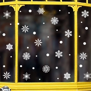 Close-up of white snowflake static stickers on a window for Christmas decoration