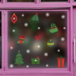 Detail view of festive Christmas window stickers featuring Santa tree, gifts, and snowflakes
