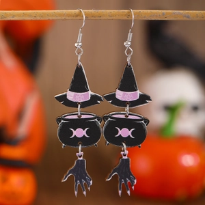 Detailed view of Halloween earrings featuring a witch hat, cauldron, and skeleton hand