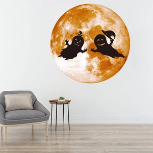 Luminous Halloween wall sticker featuring large orange moon and two flying ghost silhouettes