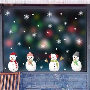 Detail of Christmas window static stickers showing four cute snowmen and white snowflakes