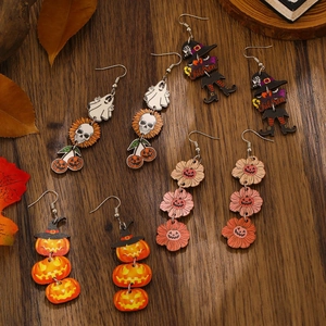 Halloween wooden drop earrings with pumpkin ghost and skull prints on dark wood background