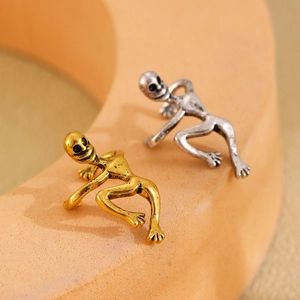 Macro shot of creative human-shaped ear cuffs in vintage gold and silver finishes