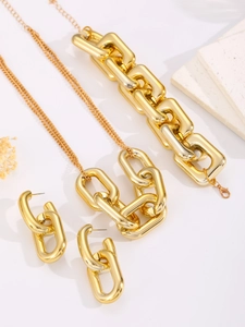 Vista de detalle de conjunto de joyas de cadena de oro con collar, pulsera y pendientes
