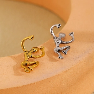 Macro view of gold and silver frog ear cuffs with vintage textured finish and details