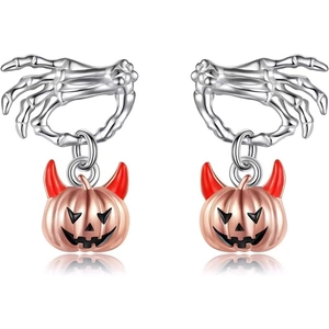 Macro detail of Halloween earrings with silver skeleton hands and red-horned pumpkins