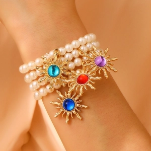 Retro multi-layer pearl bracelet with golden sun pendants and colored gemstones