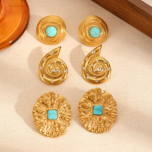 Close-up of three pairs of vintage 18k gold plated stud earrings with turquoise stones