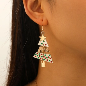 Close-up of golden Christmas tree earrings worn by model for festive holiday parties