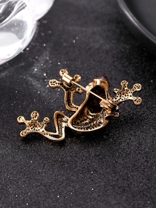 Detailed back view of gold frog brooch with metal pin clasp and textured finish