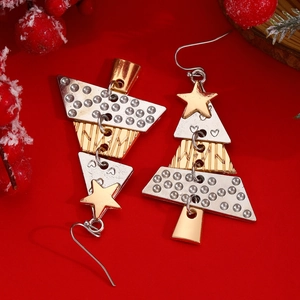 Detail of Christmas tree drop earrings with gold and silver geometric patterns on red background