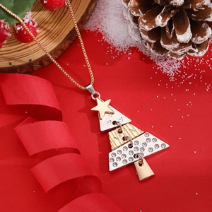 Macro view of tiered Christmas tree necklace with rhinestones on festive red background