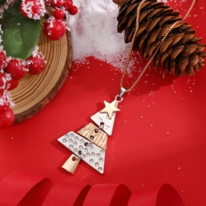 Detail of Christmas tree necklace with white rhinestones on festive red background